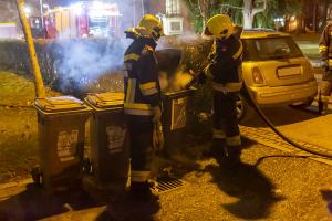 Feuerwehr löscht rauchende Mülltonne